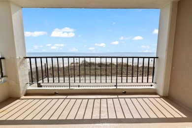 Balcony with a beach view and a water view