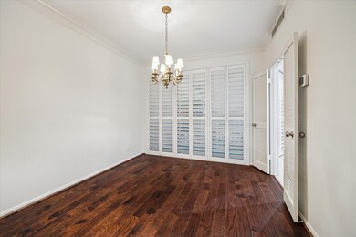 This dining room features rich wood flooring, a cl