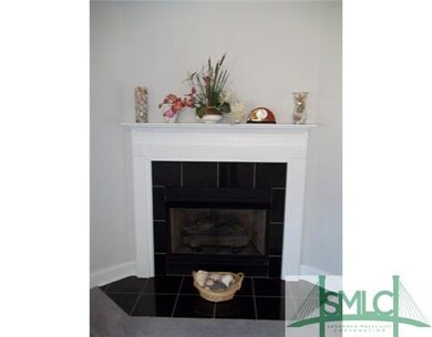 Living Room. Black marble tile surrounds gas firep