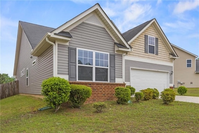 View of front of house with concrete driveway, an 