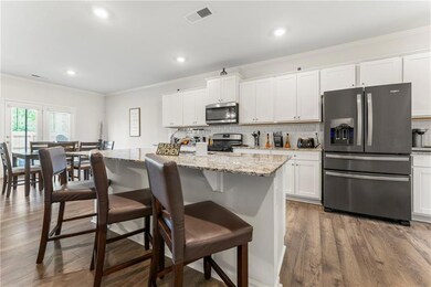 Kitchen featuring a kitchen bar, stainless steel a