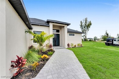 Doorway to property featuring stucco siding, a yar