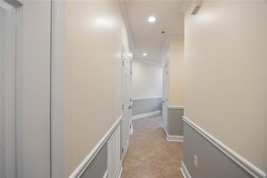 Entrance hallway with light tile patterned flooring, recessed lighting, and crown molding