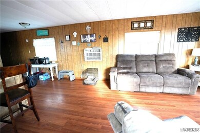 Living room with hardwood / wood-style flooring an
