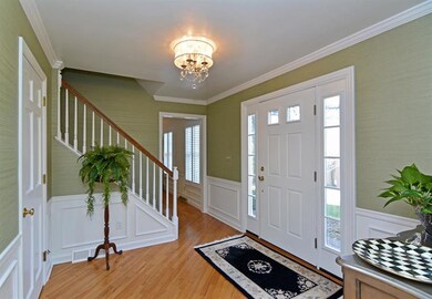 The hardwood entry greets your guests, also adorne