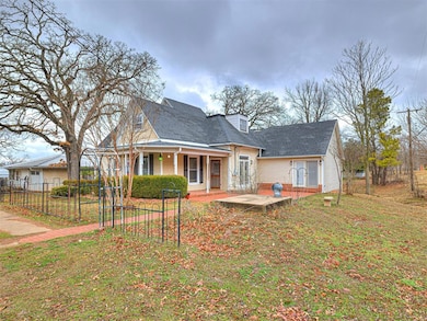 Rear view of property with a yard and covered porc