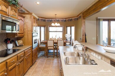 Spacious kitchen with tile floors leading to the d