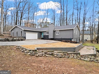 Level driveway with additional parking pad.  Terra