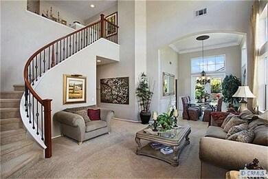 Elegant Living Room boasts a dramatic curved stair