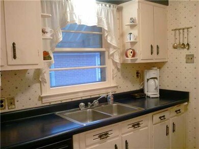 Stainless steel sink in this cute little kitchen h