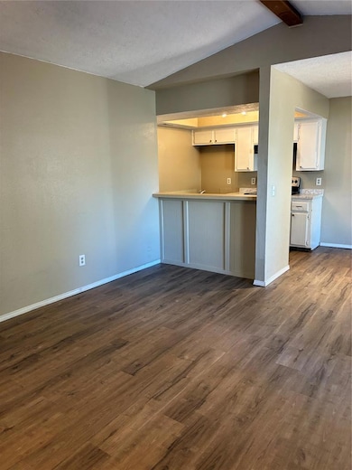 Bar area with open hand through space to kitchen ... wood-style floors