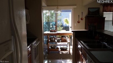 Gorgeous Galley kitchen looks out to patio