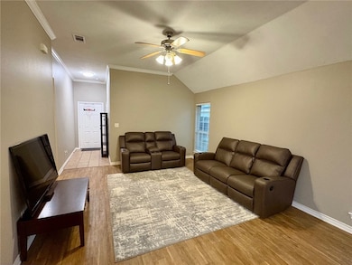 Living room featuring ceiling fan, wood finished f