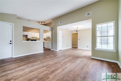 Living room looking to kitchen, front door