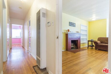Hallway separating living room and bedrooms