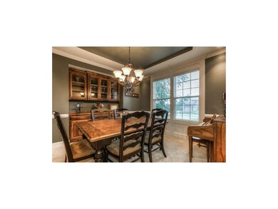 Roomy dining room with sculpted ceilings and large