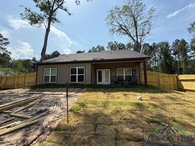 Rear view of house featuring french doors, a fenced backyard, and a gate
