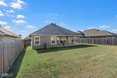 Back of house featuring a patio, a fenced backyard, and roof with shingles