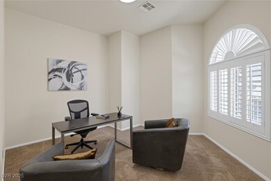 Carpeted office with visible vents and baseboards