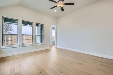 Unfurnished room featuring lofted ceiling, light h
