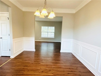 Unfurnished dining area featuring dark wood-type f