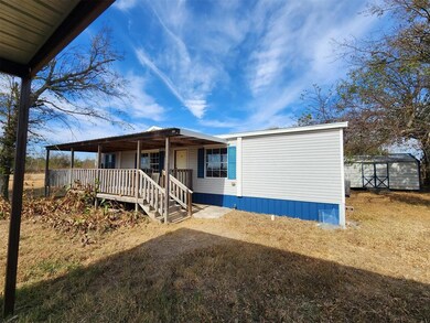 View of front facade featuring a shed and a front 