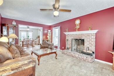 Family room with woodburning fireplace.