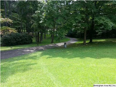 top of lot in front of house.