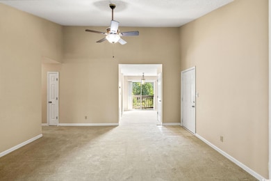 Spare room with a high ceiling, light carpet, ceil