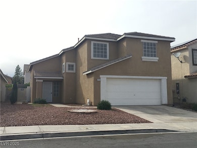 Traditional-style house with stucco siding, driveway, a tiled roof, and a garage