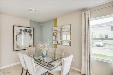 Dining space with light tile patterned floors