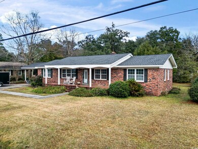 Ranch-style home with covered porch and a front ya
