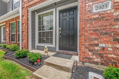 Property entrance featuring brick siding and a por