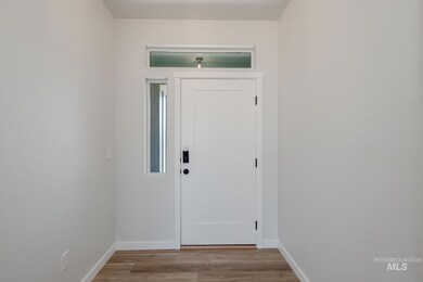 Entrance foyer featuring baseboards and light wood-style flooring