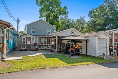 Back of property featuring a gazebo, a lawn, a patio area, and a deck