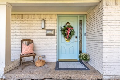 Entrance to property featuring brick siding