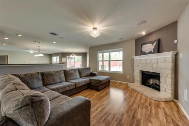 Living room features a cozy stone fireplace and ha
