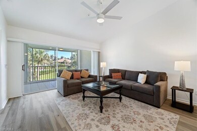 Living room featuring ceiling fan, wood finished f