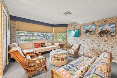 Living room with carpet floors and a textured ceil