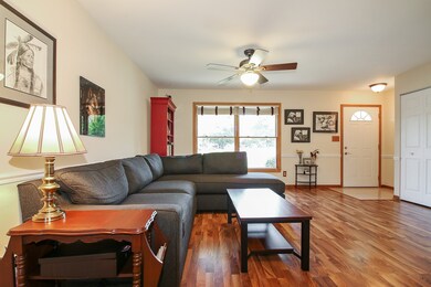 Large living room with laminate wood flooring. 