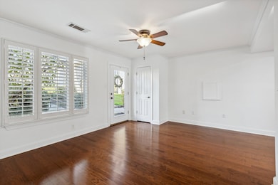 Entryway featuring crown molding, a ceiling fan, b