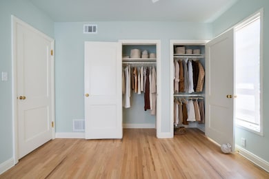 Unfurnished bedroom with light wood-style floorin