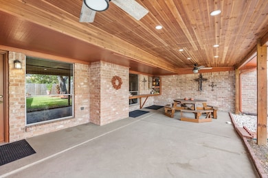 Spacious and extended covered patio with ceiling fans and lighting for ultimate comfort.