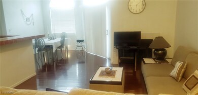 Living room with dark wood-style floors and baseboards