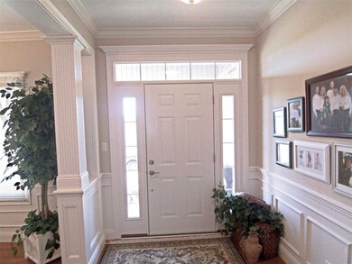 The foyer with transom window opens to the...