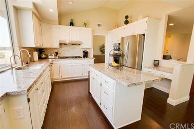 The kitchen has a large island and a desk space.
