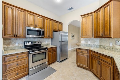 Kitchen with visible vents, appliances with stainl