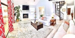 Living room featuring vaulted ceiling and light ha