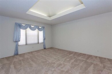 Separate living room with custom ceiling.