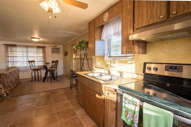 Kitchen blends nicely into spacious Living/Great Room. Ceramic tile floor and ceiling fan in kitchen.